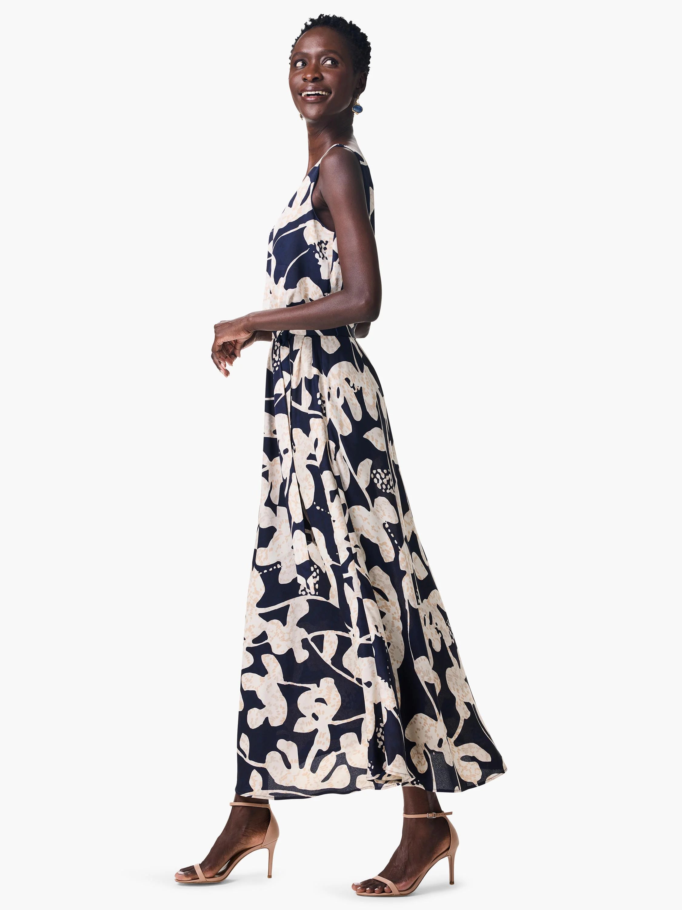 Maxi dress, sleeveless, navy blue background, cream colored abstract floral print.