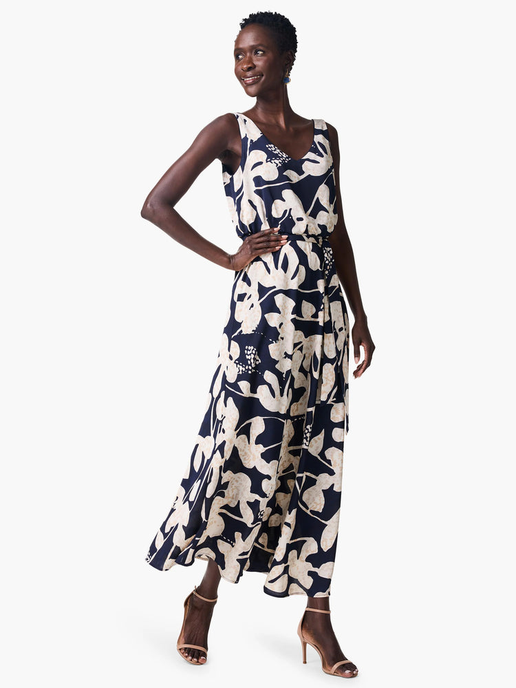 Navy & beige maxi dress with a sleeveless bodice, V-neck, and a large-scale abstract floral print.  It has a wrap-style...