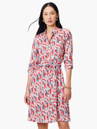 Shirt dress with red, blue, and beige abstract print.  Belted waist, three-quarter sleeves.