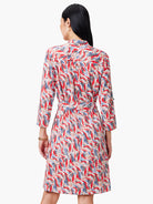Red, blue, and beige patterned shirt dress with a belted waist and three-quarter sleeves.