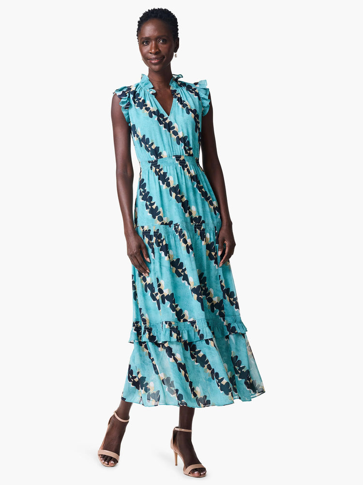 Teal maxi dress with a V-neck, ruffled sleeves and hem. Features a dark blue and beige leaf print.  Sleeveless.