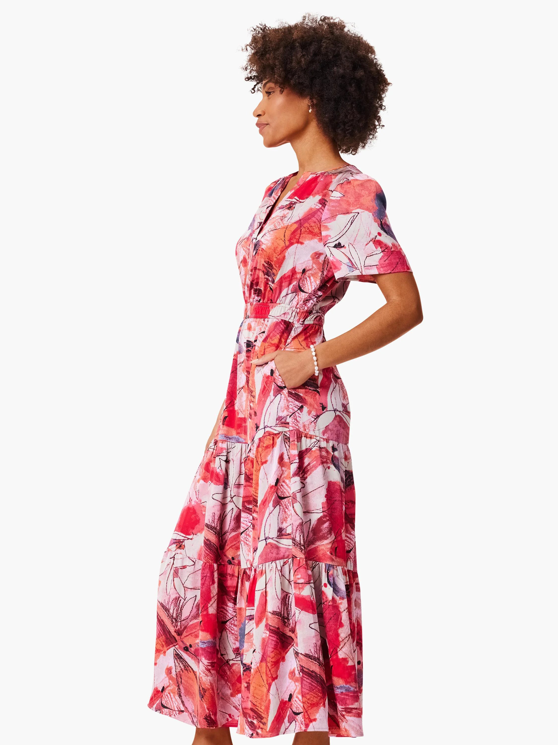 Mid-length tiered dress, pink and red abstract print, short sleeves, V-neck.