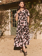 Maxi dress, black & mauve abstract print, short sleeves, tiered skirt, and pockets.