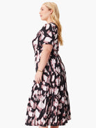 Midi dress, black background with mauve and white abstract print. Short sleeves, tiered skirt.