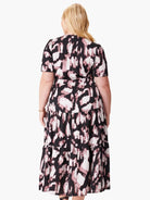 Black midi dress with mauve abstract print. Short sleeves, tiered skirt.