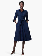 Navy blue midi shirt dress with a tie waist, button front, and pockets.  A-line skirt.