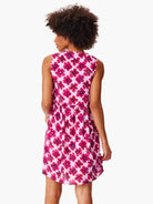 Pink sleeveless mini dress with a red floral print.  The back shows a gathered waist.