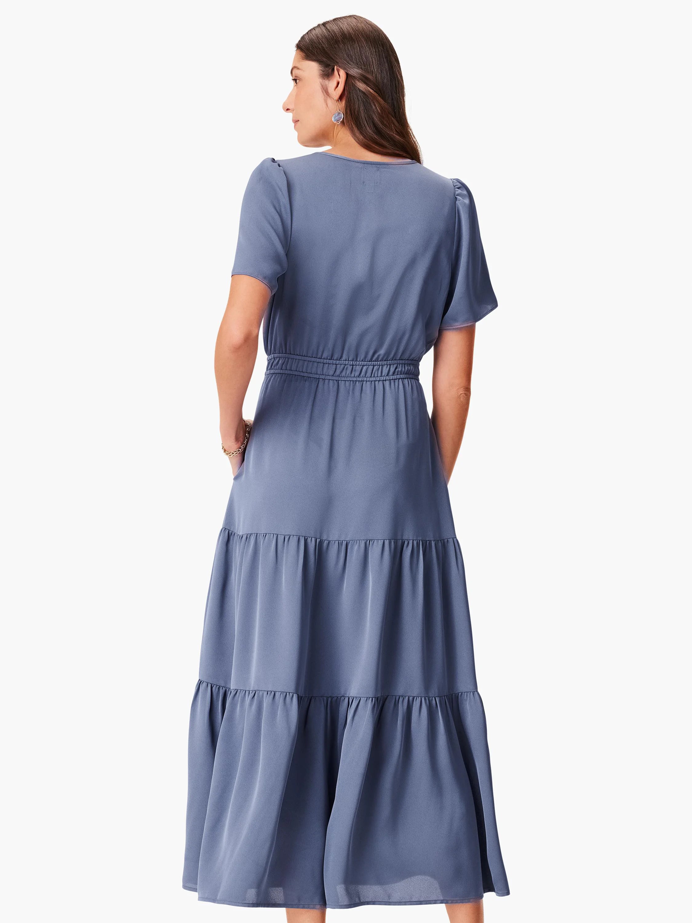 Muted blue maxi dress with short puff sleeves, elastic waist, tiered skirt, and side pockets.