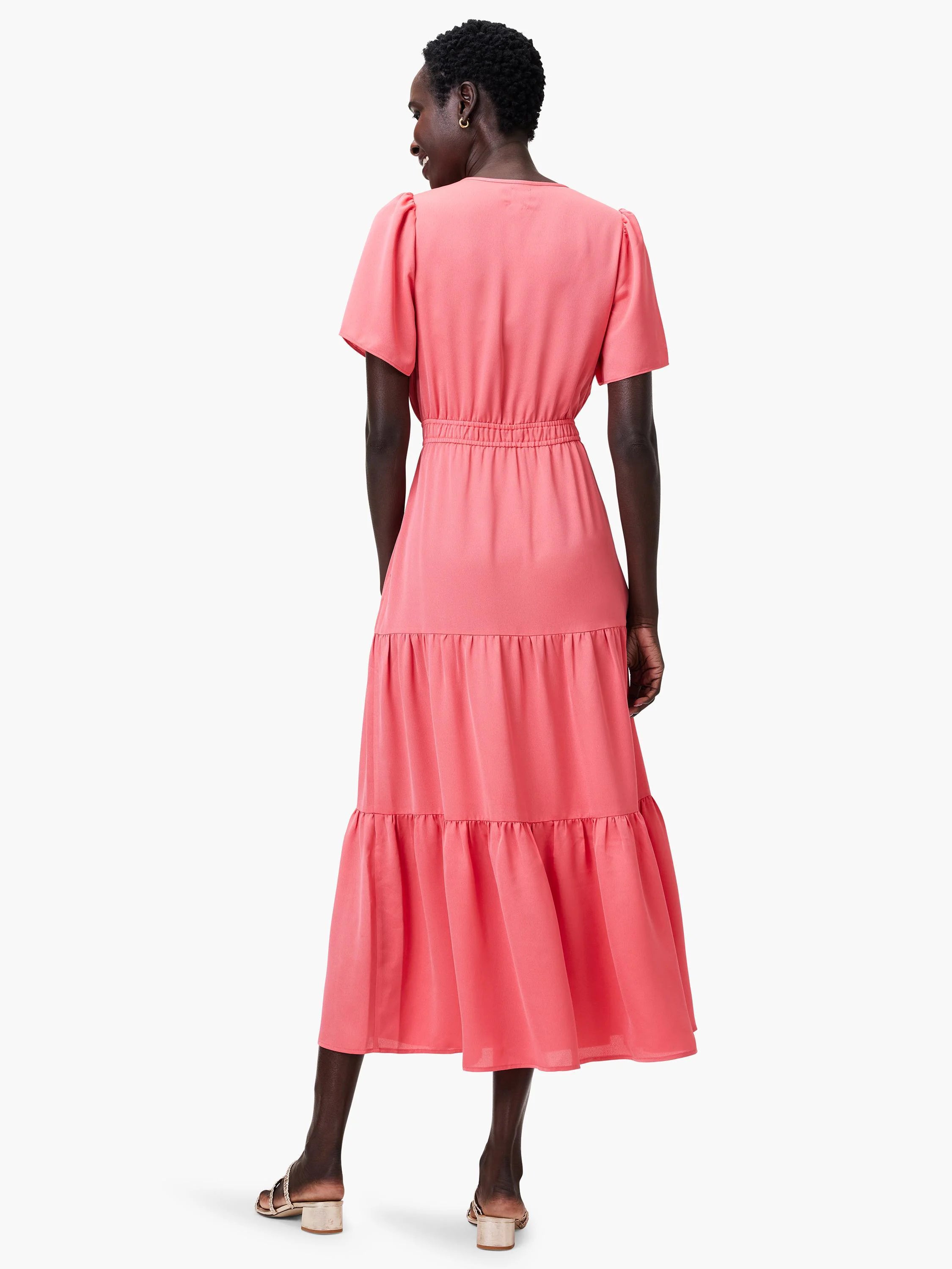 Coral pink midi dress with short puff sleeves, smocked waist, and tiered skirt, shown from the back.