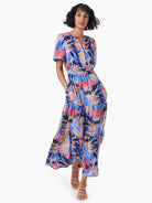 Maxi dress, blue background,  pink, coral, and beige floral print. Short sleeves, tiered skirt.