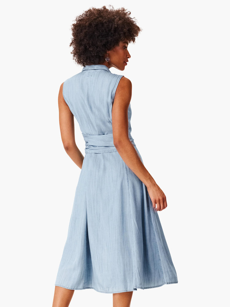 Light blue denim shirtdress, sleeveless, midi length, belted waist, A-line skirt.