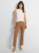 White sleeveless tank with a collar, V-neck, and layered front detail.