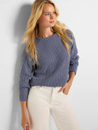 Navy and white knit top with a textured vertical zig-zag pattern and round neck.