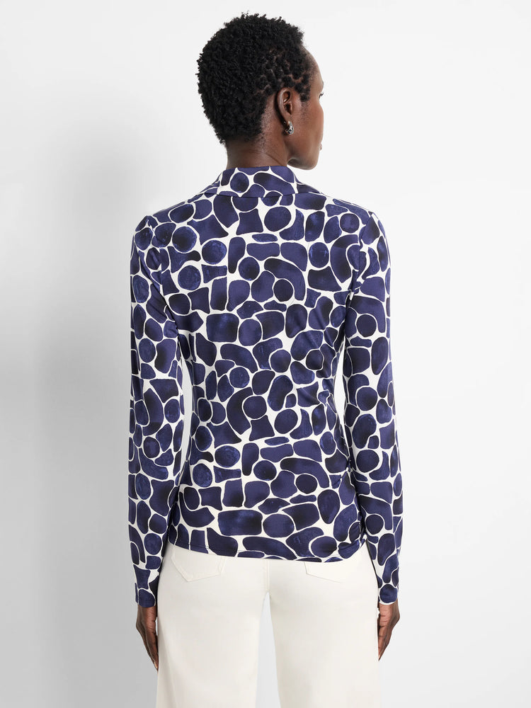 Back of a long-sleeved top with a navy blue and white irregular pebble pattern.