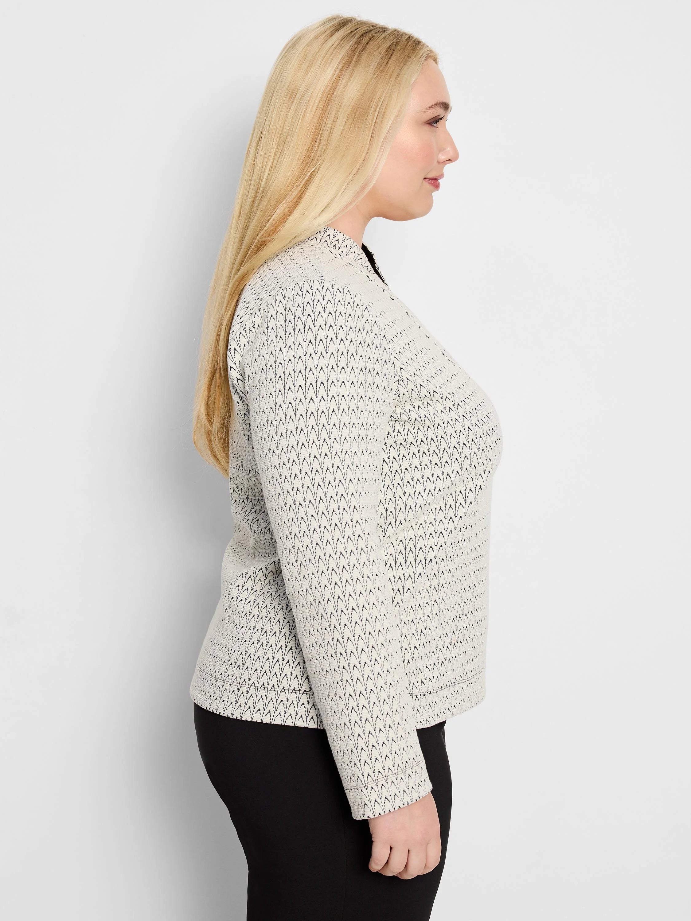 Light cream knit top with a black, repeating chevron pattern creating a subtle swirl.