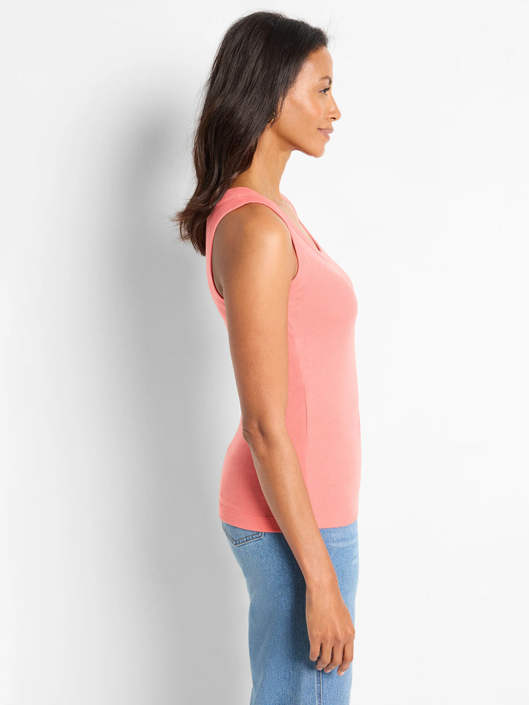 Coral pink ribbed knit scoop neck tank top on a woman.
