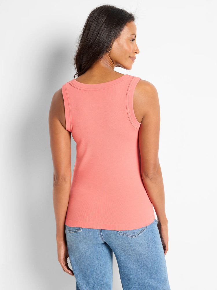 Peach ribbed knit tank top. Back view shows wide scoop neckline and close fit on model.