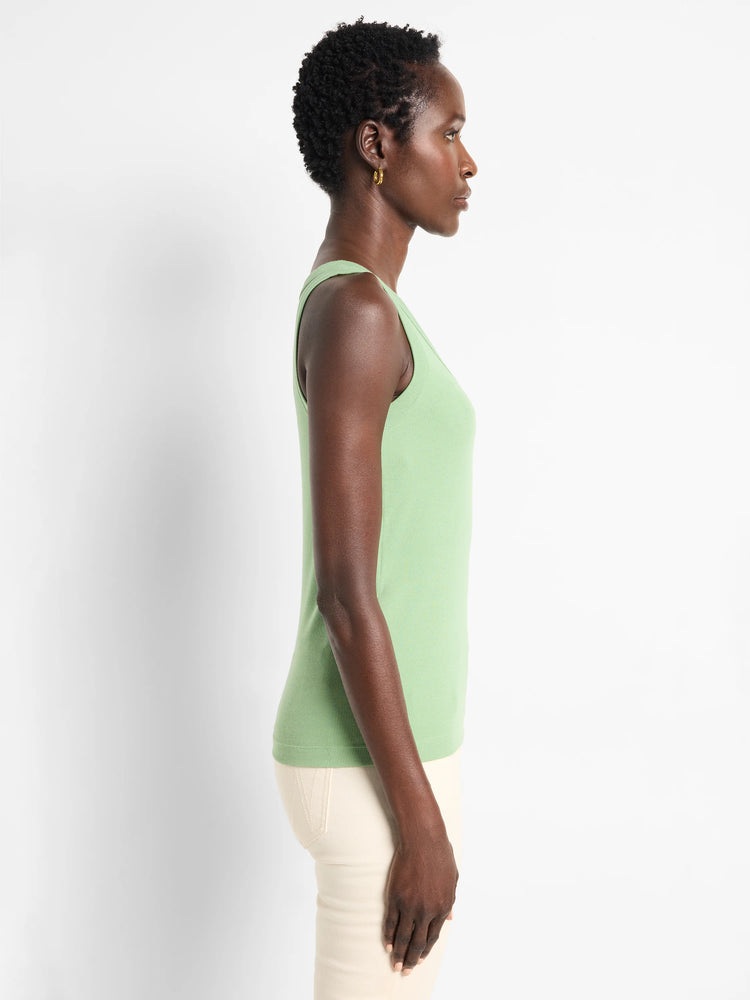Light green ribbed knit scoop neck tank top shown on a model from the side. It has a close-fitting silhouette.
