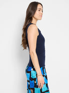 Dark navy sleeveless tank top with a close fit and subtle gathering along the left side seam.