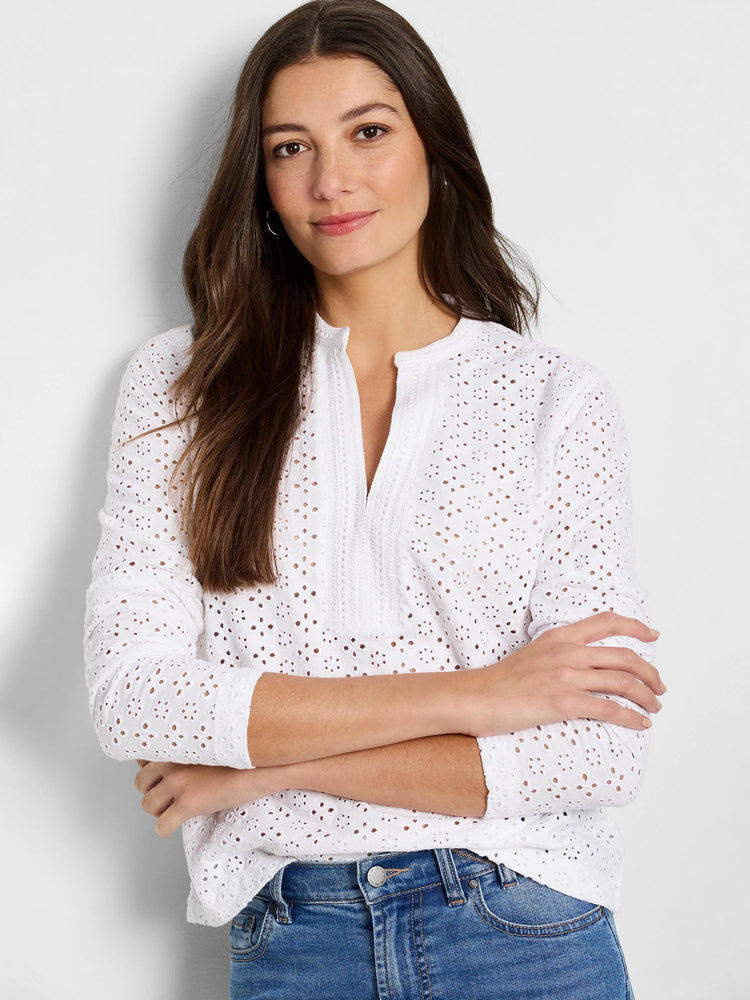 White top with all-over eyelet knit pattern, split neck, and long sleeves.