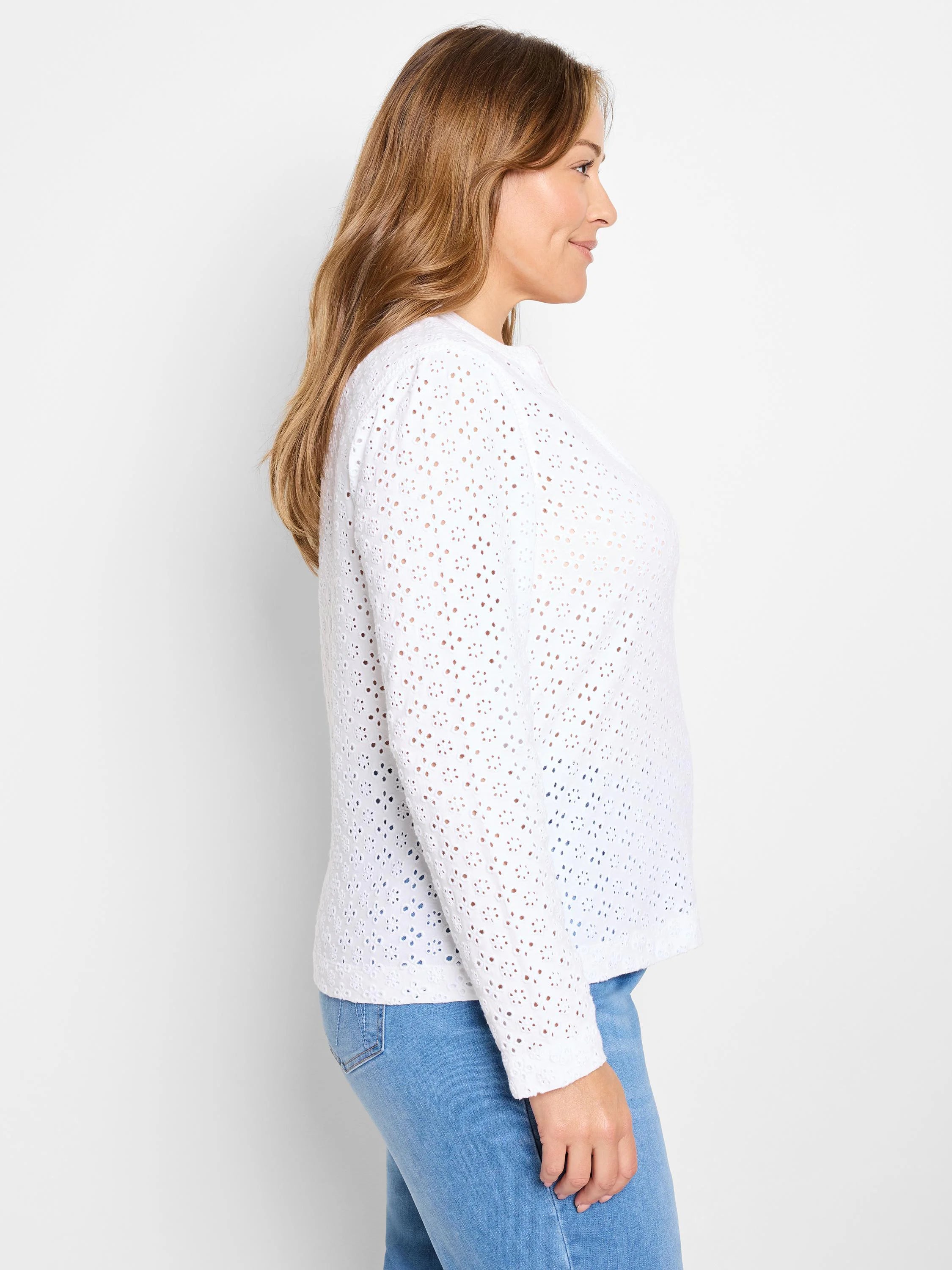White knit eyelet long-sleeve top with small textured holes.