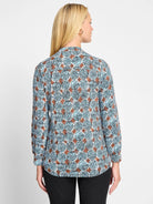 Long-sleeve top with an aqua, brown, and white sand dollar pattern.