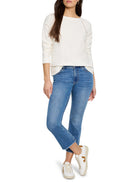 Off-white textured long-sleeve top with boat neck and decorative open-knit seams on shoulders and sides.