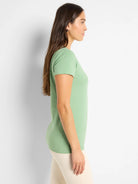 Light green knit crew neck t-shirt with short sleeves, shown on a model in profile.