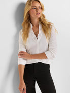 White long-sleeved shirt with a ruffled V-neckline and cuffed sleeves.