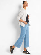 Black knit tank with a round neckline, shown partially beneath an open cardigan.