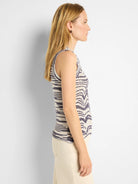 Sleeveless off-white and indigo knit tank with mixed horizontal stripe and zigzag patterns.