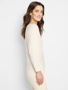 Light cream V-neck sweater with long sleeves, ribbed cuffs and hem.