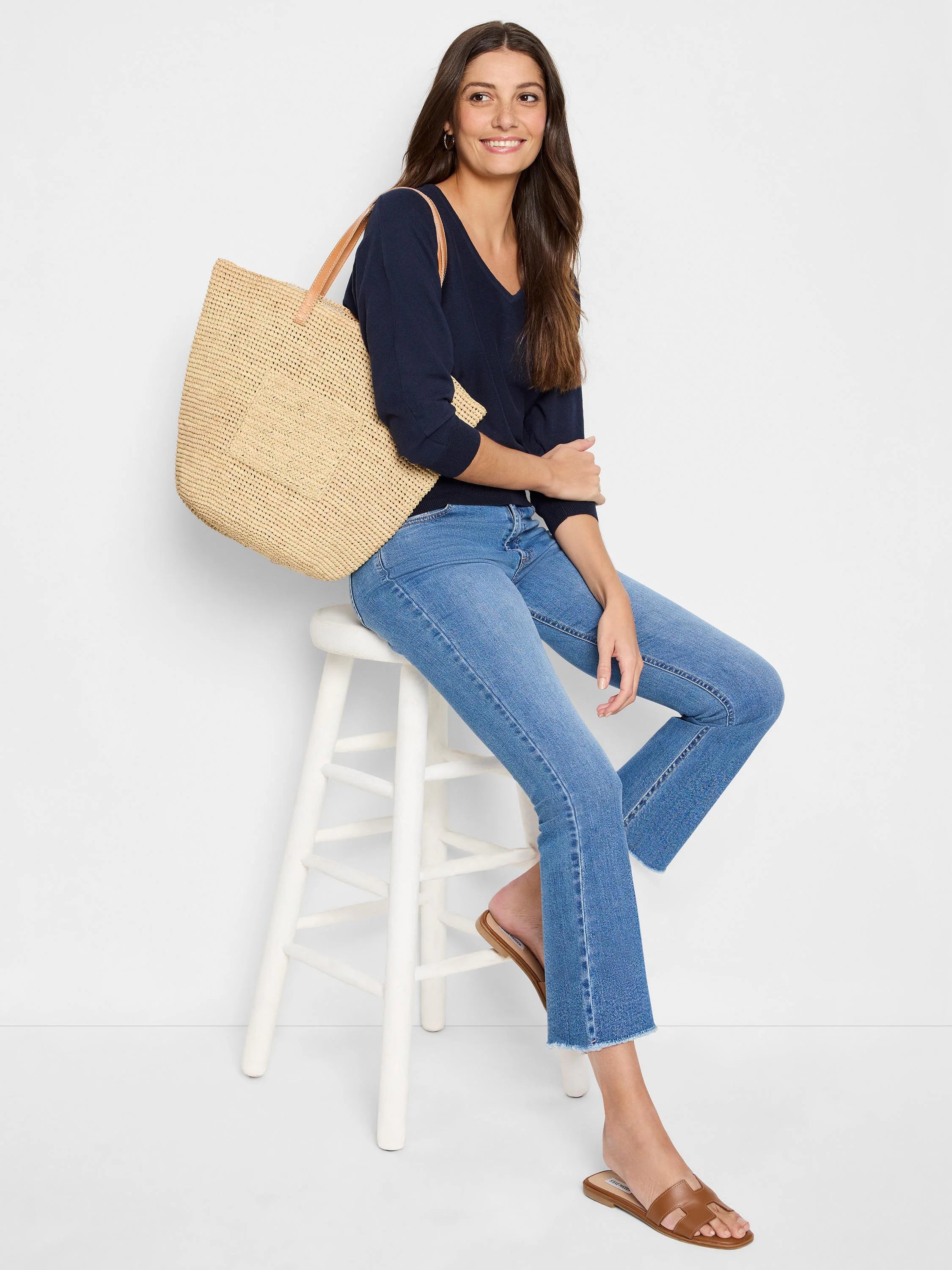 Navy blue V-neck sweater, finely knit, with long sleeves and a relaxed fit.