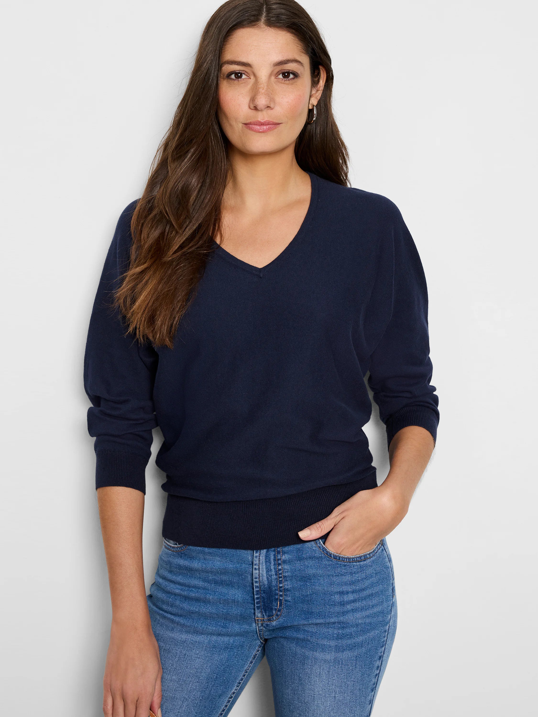 Navy blue V-neck sweater with long, slightly dropped sleeves, ribbed cuffs and hem.