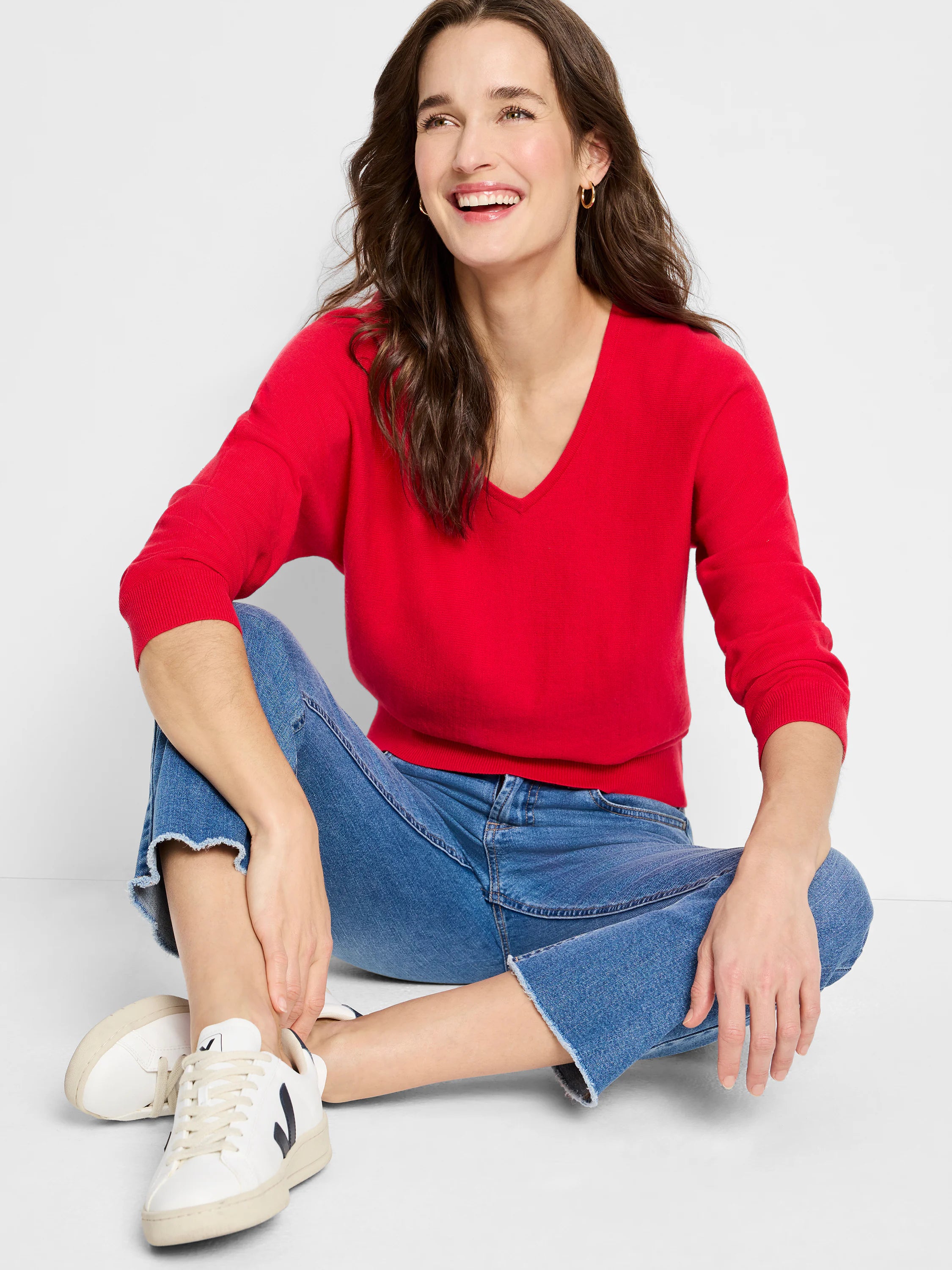 Red V-neck sweater with long sleeves, ribbed cuffs and hem.