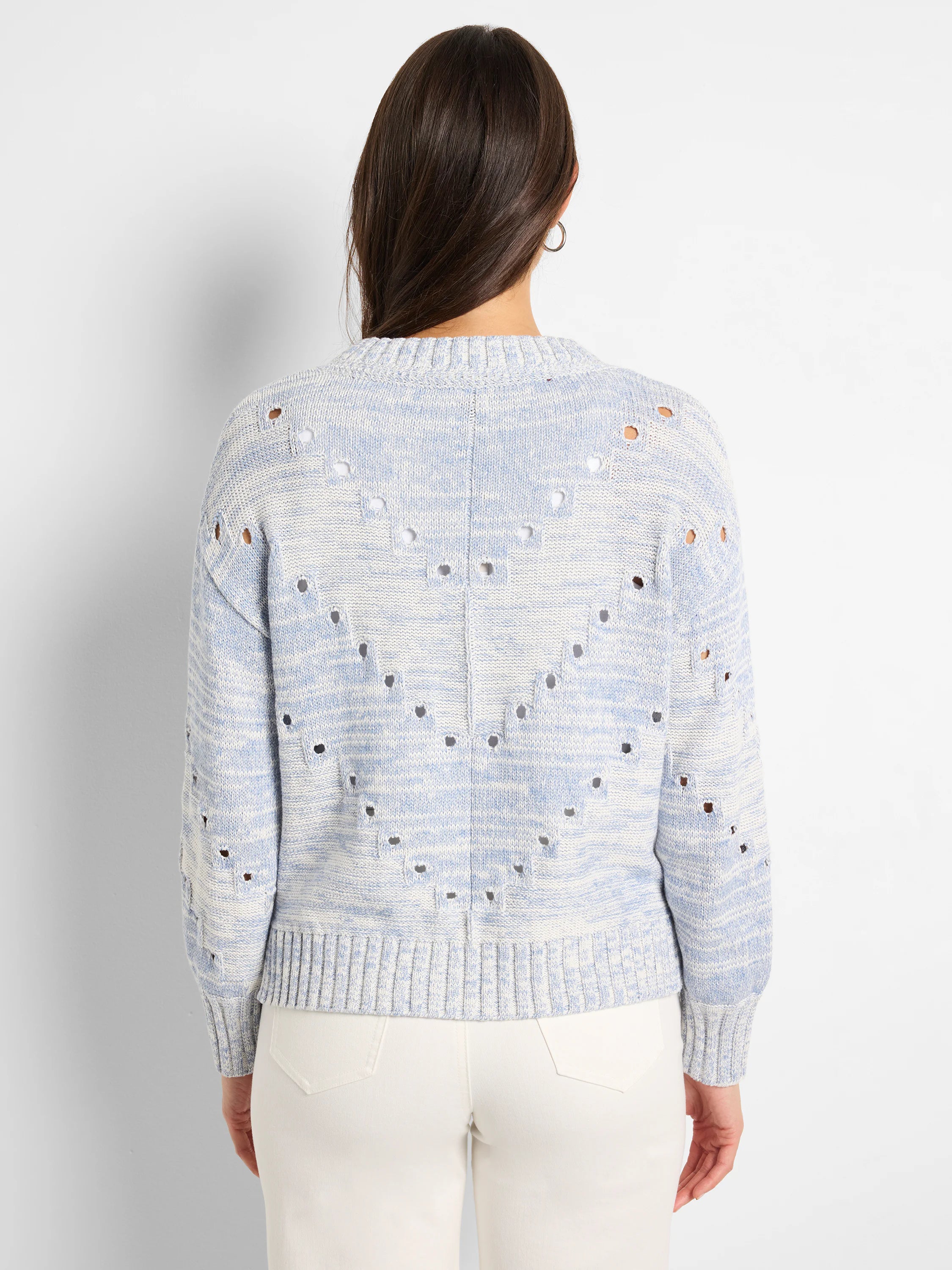 Back of light blue & white pointelle sweater with V-patterned holes across back and sleeves.