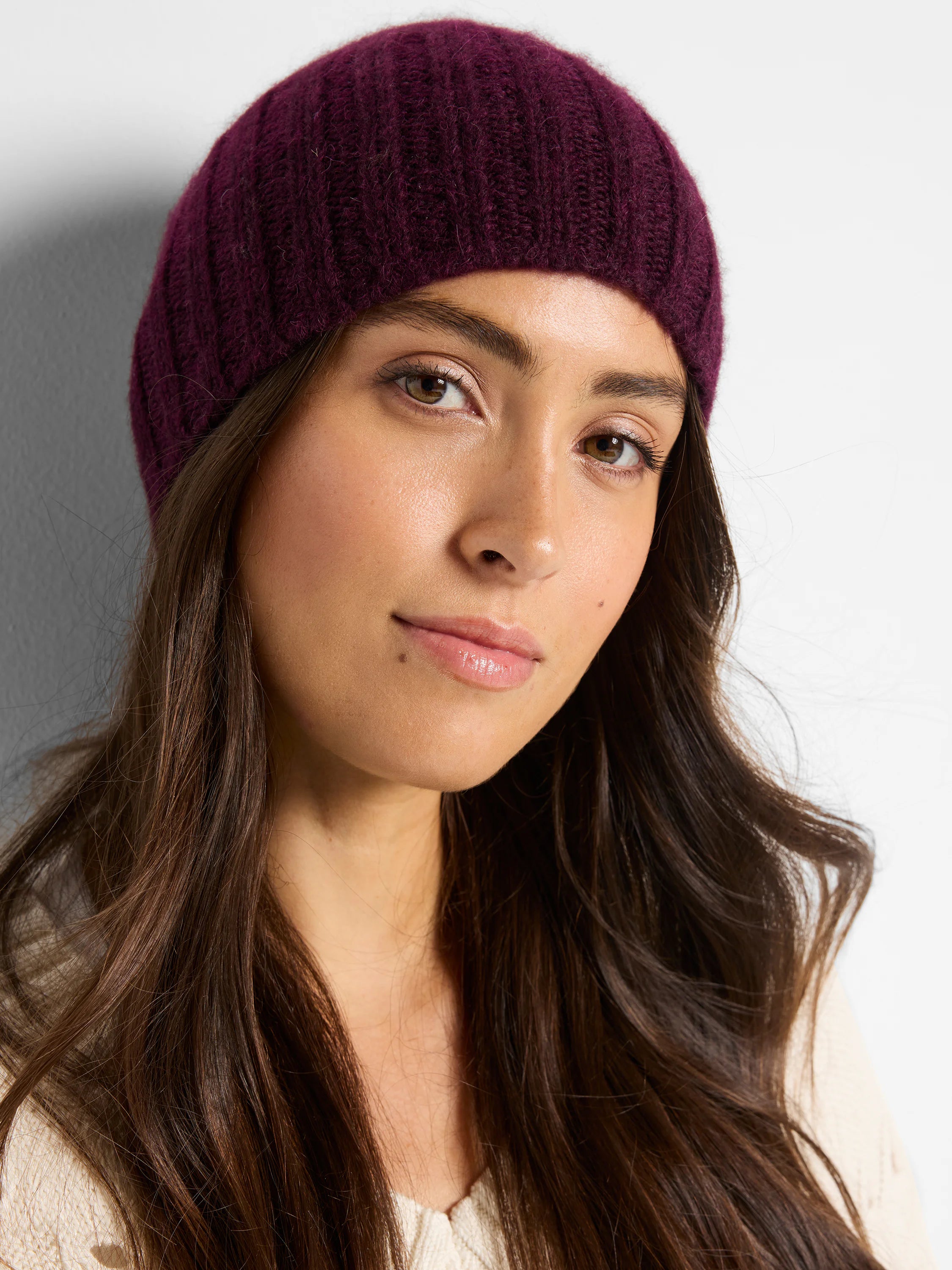 Close-up of cream Pointelle Cord Sweater, showing textured knit on model's neck and chest.