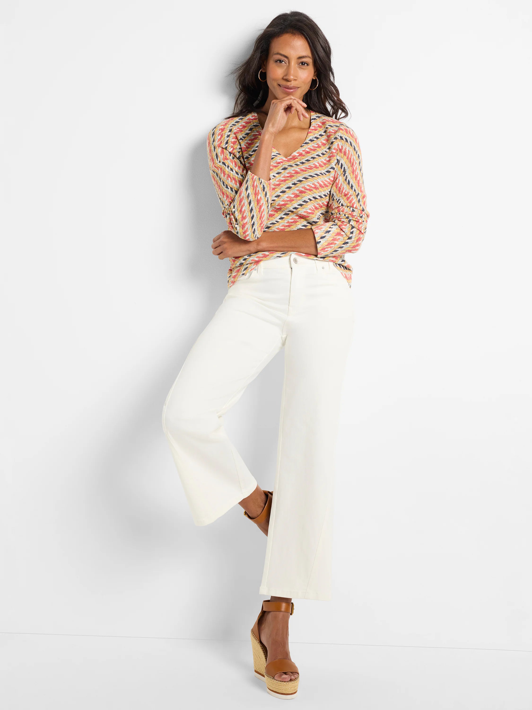 Textured sweater with V-neck, featuring a zig-zag pattern in coral, yellow, light blue, and cream colors.