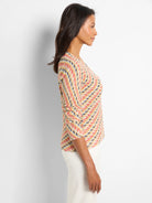 Textured knit sweater: multi-color pattern in coral, yellow, teal, black, cream. 3/4 sleeves, V-neck.