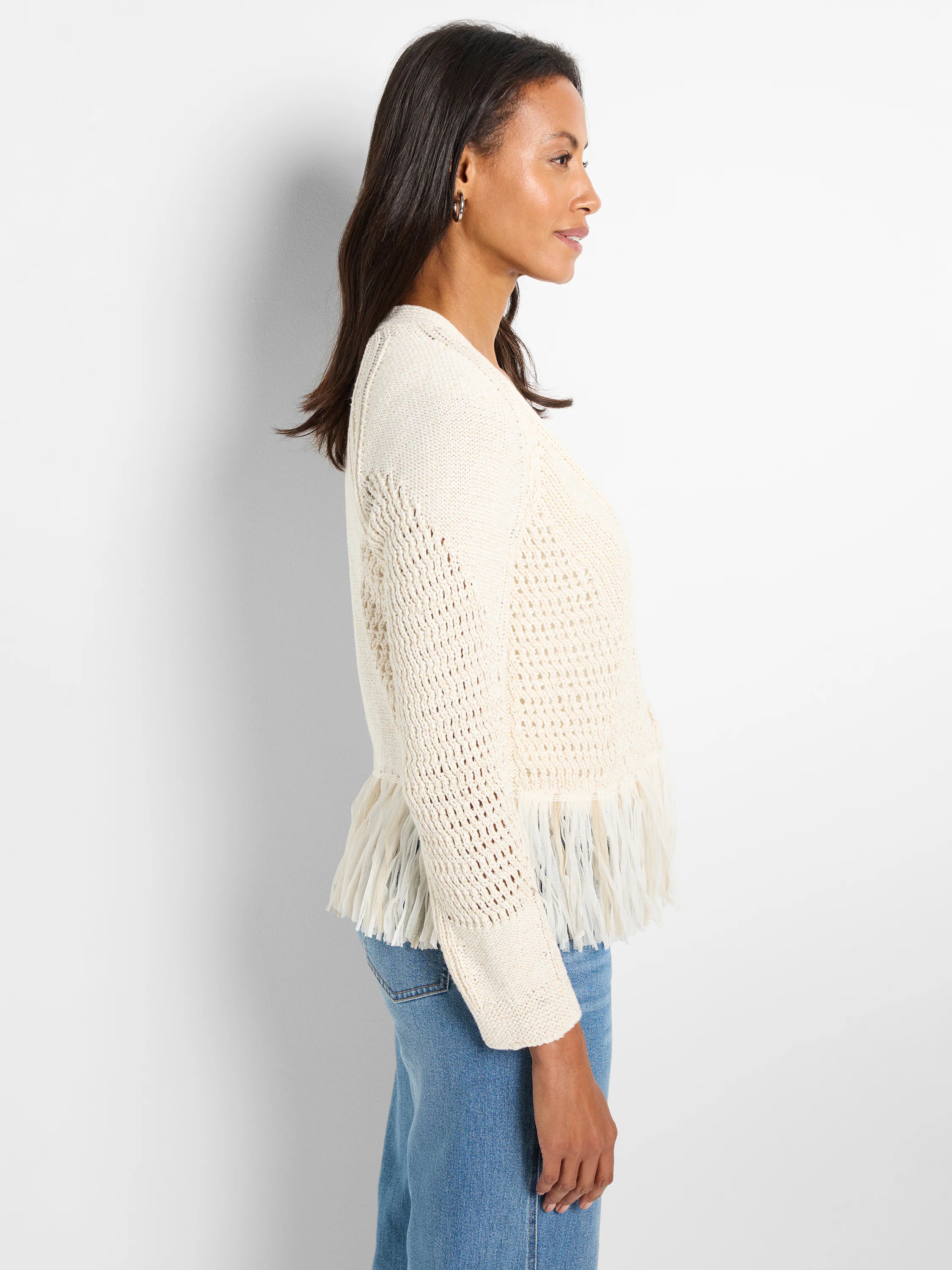 Cream open-knit cardigan with textured sleeves and tiered tape fringe hem.