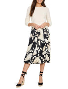 Cream garter knit crew neck sweater with long sleeves, shown on a model.