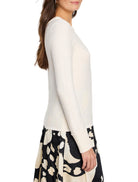 Cream baby garter knit crew neck sweater with ribbed cuffs, modeled.