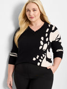 Black sweater with off-white abstract design, V-neck, and 3/4 sleeves.