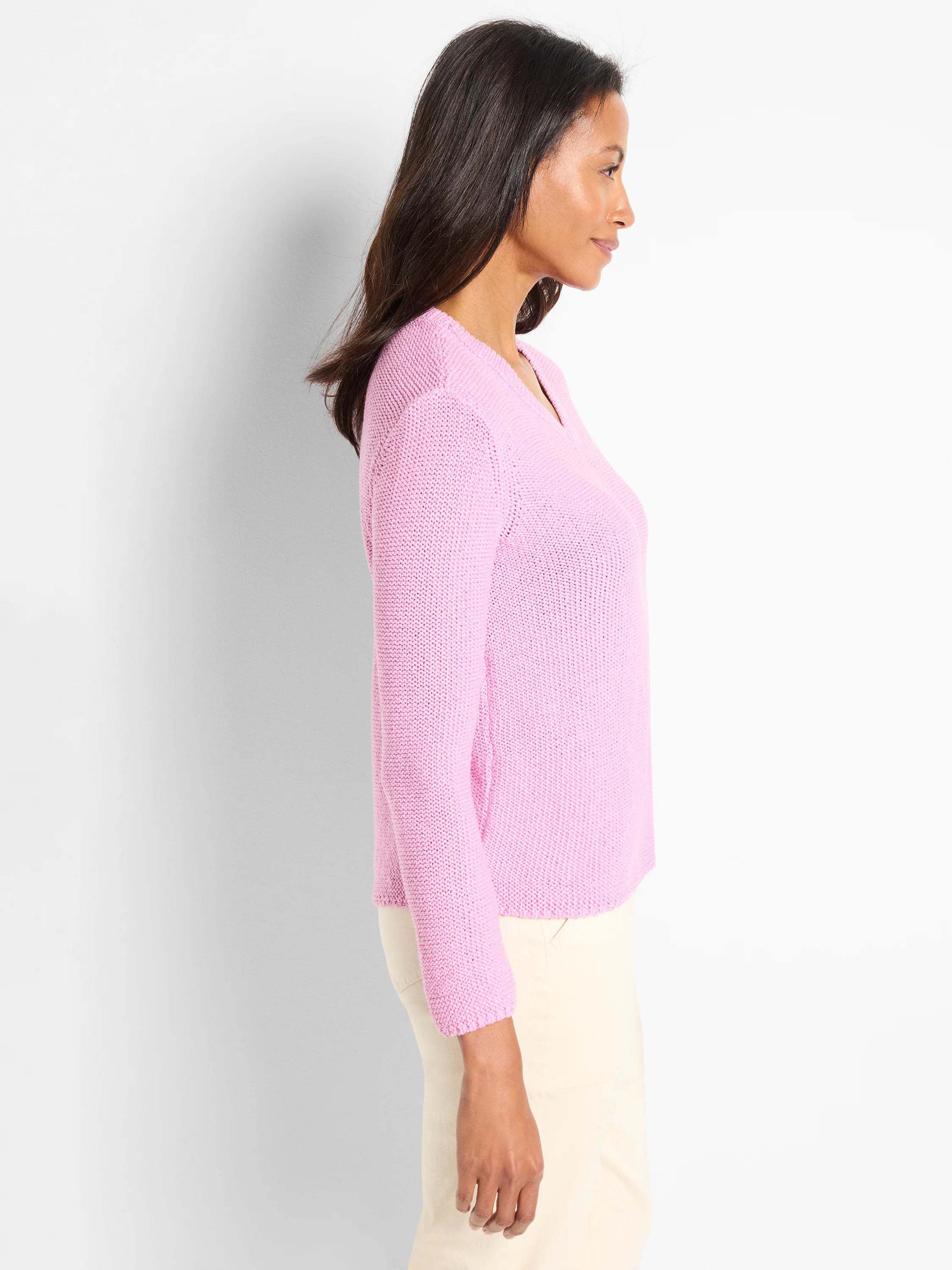 Light pink, V-neck, long-sleeved, loosely knit sweater.  Shown on model.