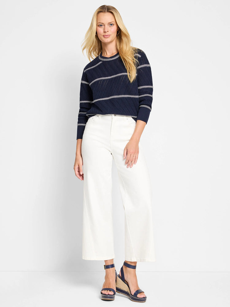 Navy blue pointelle sweater with thin, lighter stripes.  Crew neck, long sleeves.