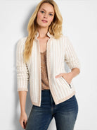 Off-white knit jacket with thin brown pinstripes, notch collar, and zippered pockets.  Brown trim details.