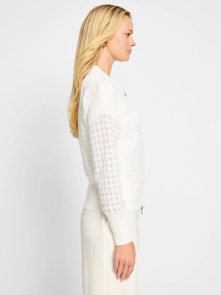 Off-white sheer knit cardigan.  Stitched pattern on sleeves.  Long sleeves, zip front.