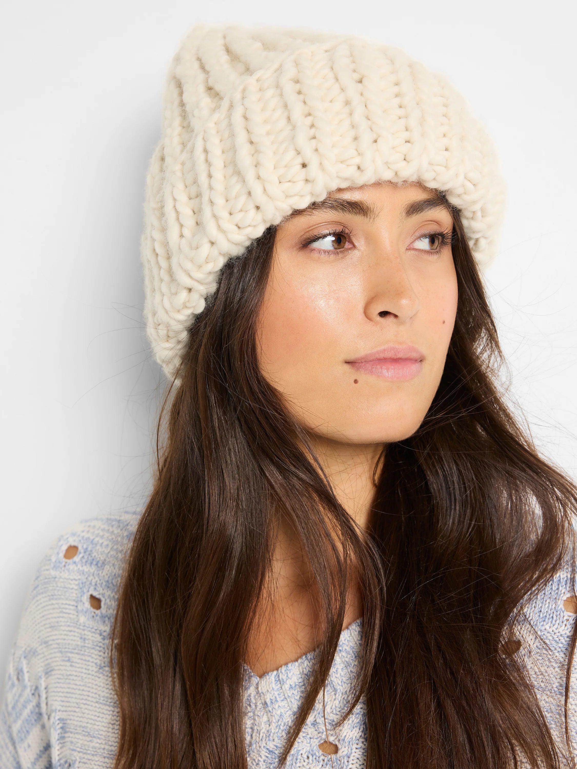 Off-white chunky knit beanie.  Cable knit texture.