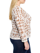 Off-white sweater with brown textured diamond pattern.  Long sleeves.