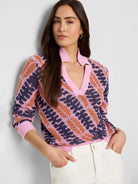 Pink, orange, and navy blue jacquard knit sweater.  V-neck, squiggle pattern.  Long sleeves.